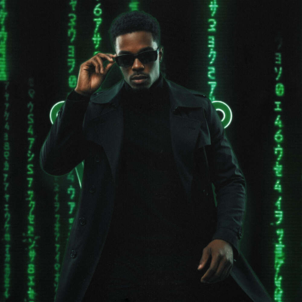 K.R.W.N. standing in a dark trench coat and sunglasses, matrix code background